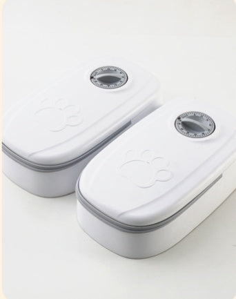 Automatic pet feeder from Nick's Super Store, no electricity needed, with a transparent food container and dispensing mechanism.