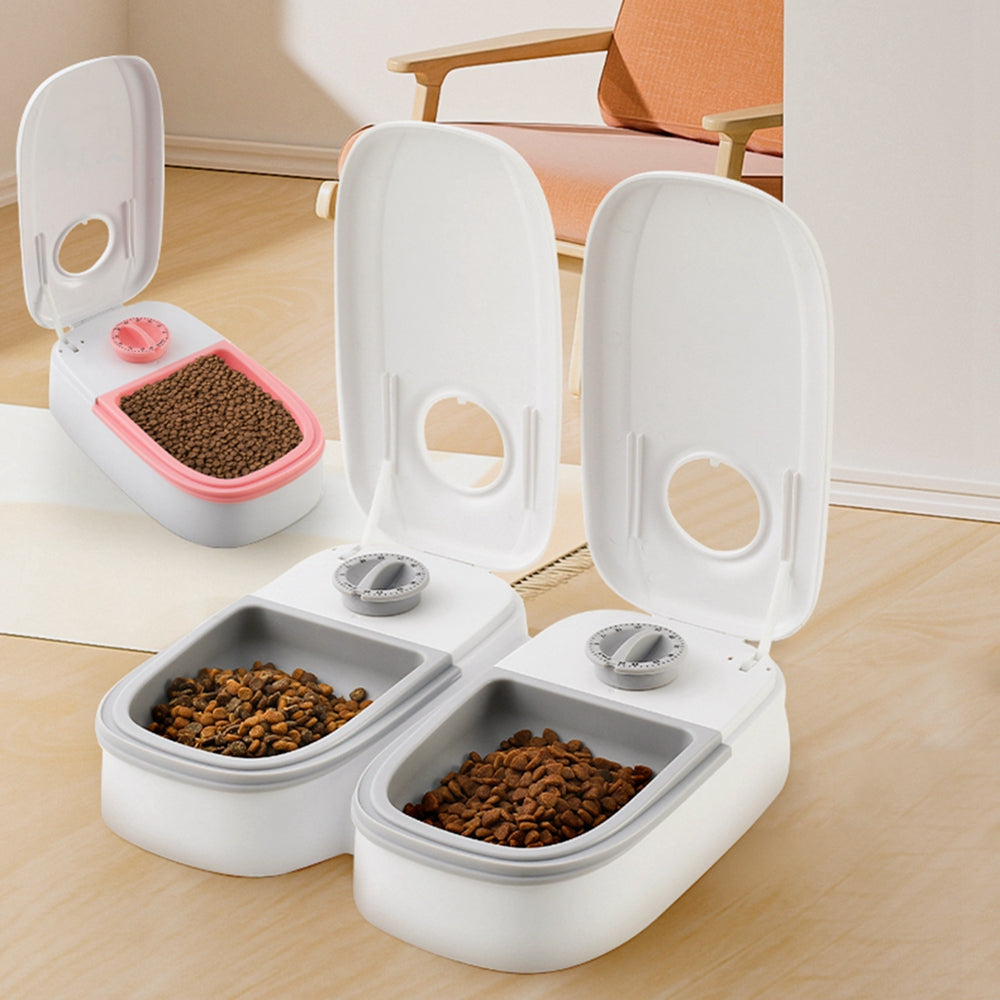 Smart automatic pet feeder from Nick's Super Store, no electricity needed, with food compartments and feeding mechanism for pets.