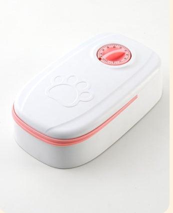Automatic pet feeder by Nick's Super Store, no electricity needed, with clear food dispensing tray and secure lid for pet feeding.