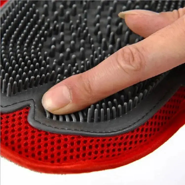 Black dog grooming brush by Nick's Super Store for gentle hair removal and spa-like brushing sessions on soft grain surfaces.