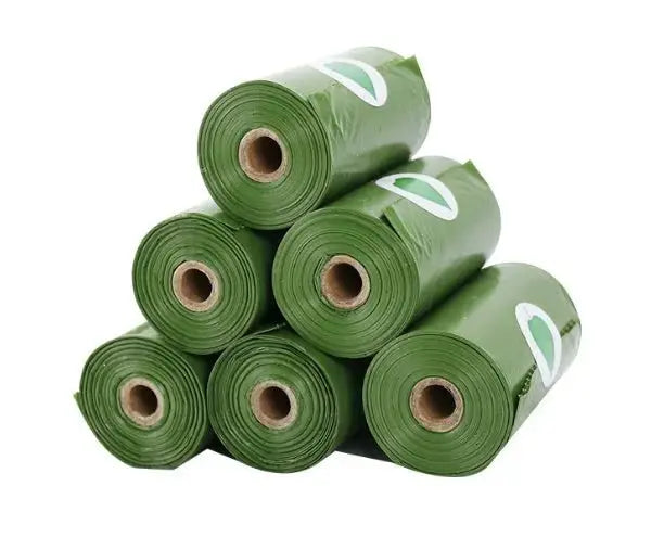 Army green biodegradable pet waste bags with dispenser, shown in a boxed set with multiple rolls from Nick's Super Store.